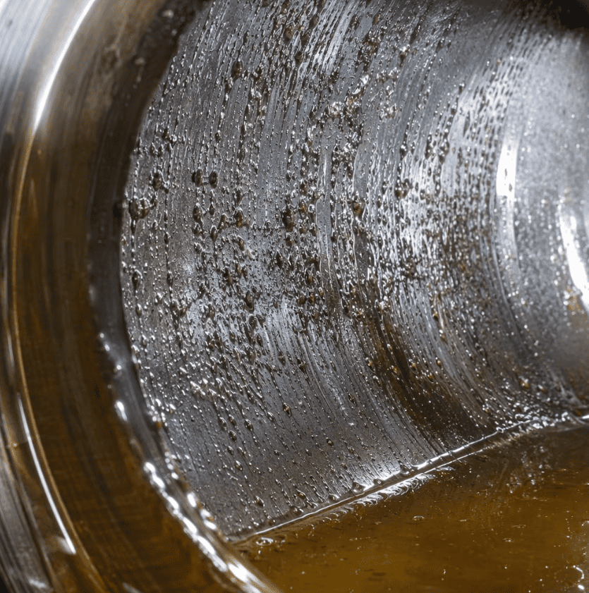 Macro photography of hydraulic cylinder barrel pitting caused by air implosion